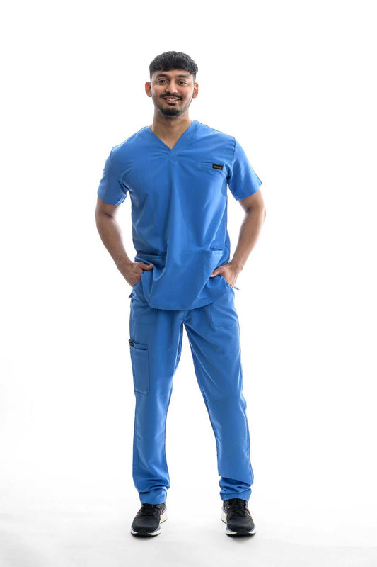 professional scrubs Skyward Bound Scrubs Set in blue worn by a person standing, showcasing comfort and functionality with multiple pockets