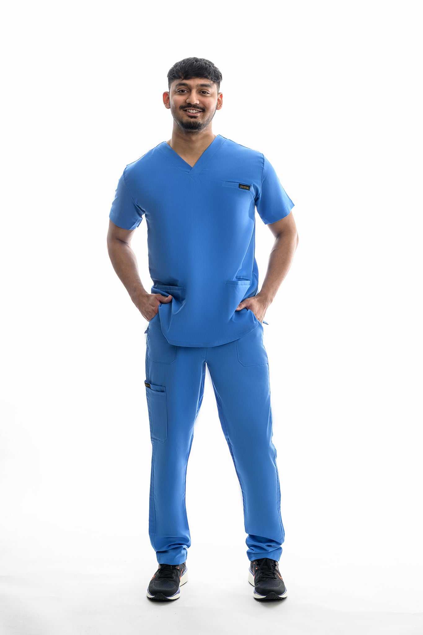 Man wearing blue Skyward Bound Scrub Set with V-neck, multiple pockets, and straight leg pants
