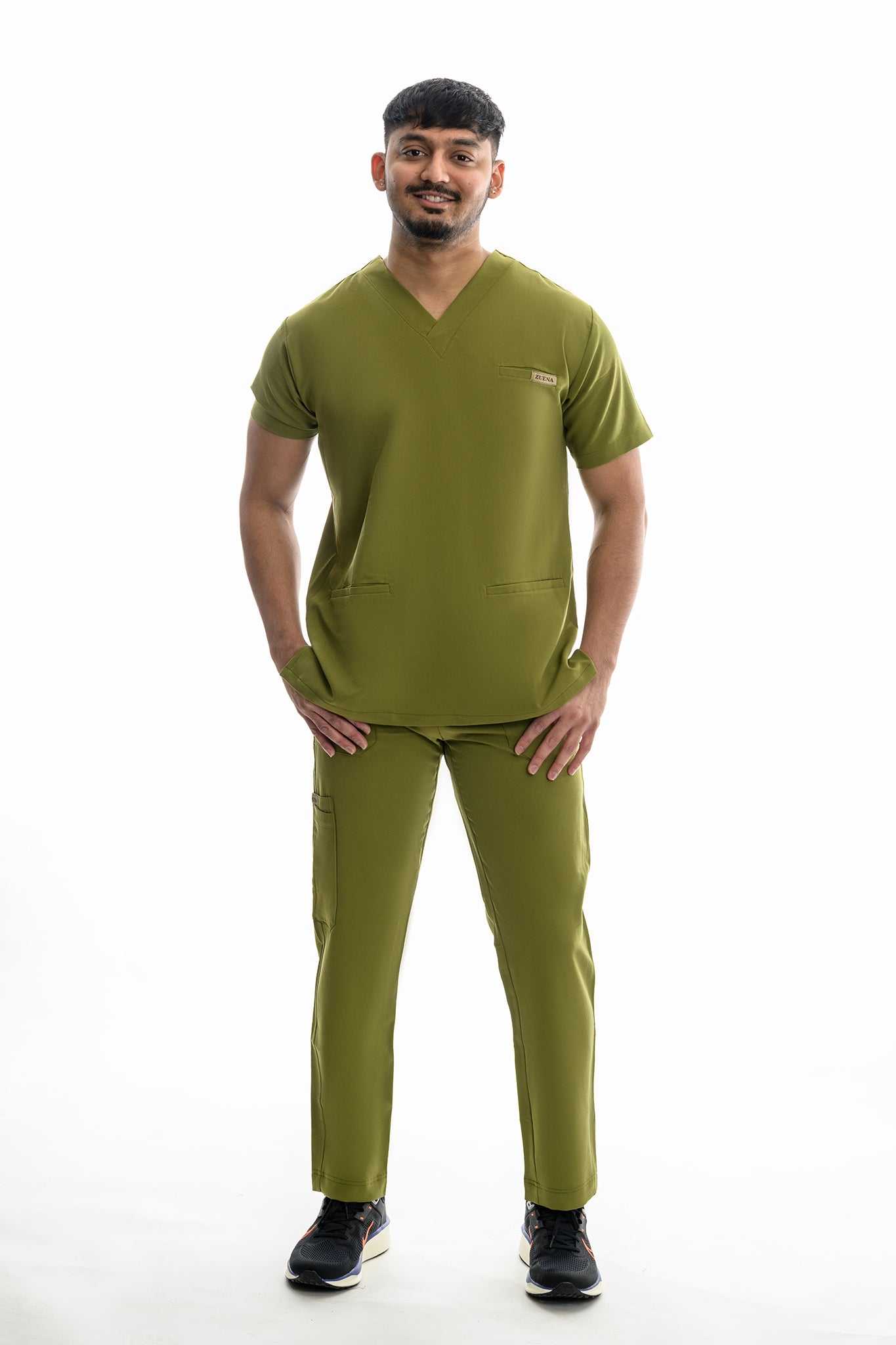 Man wearing Zuena Olive Scrub Set for men with straight leg scrub pants and elastic waistband, featuring five pockets.