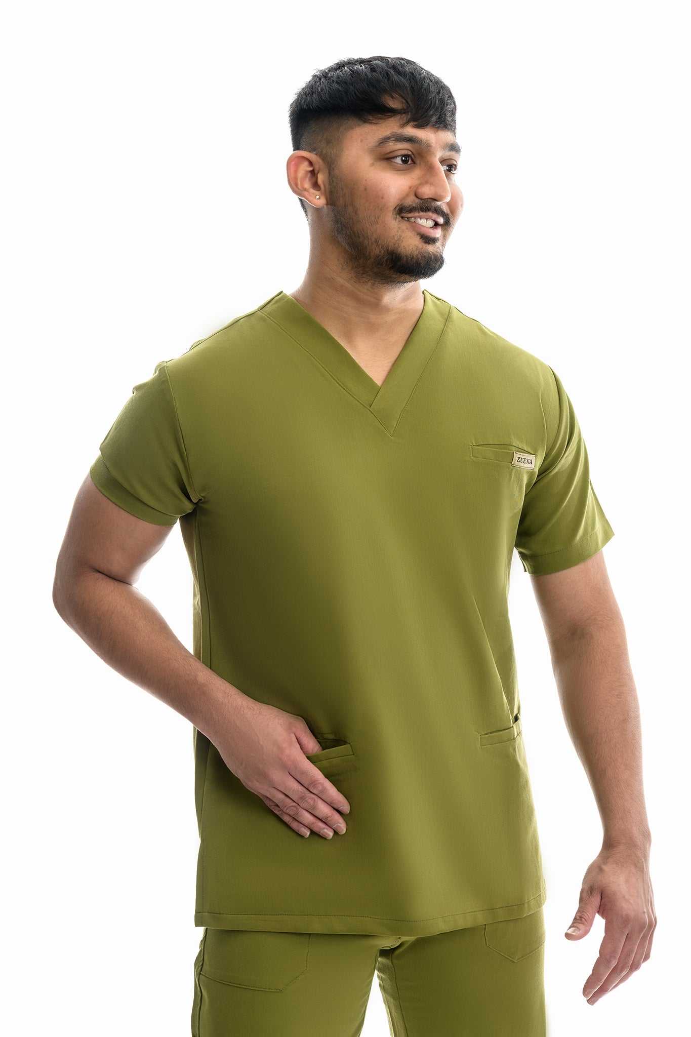 Man wearing Zuena Olive Groove Scrub Top with curved neck, short sleeves, three pockets, and side vents.