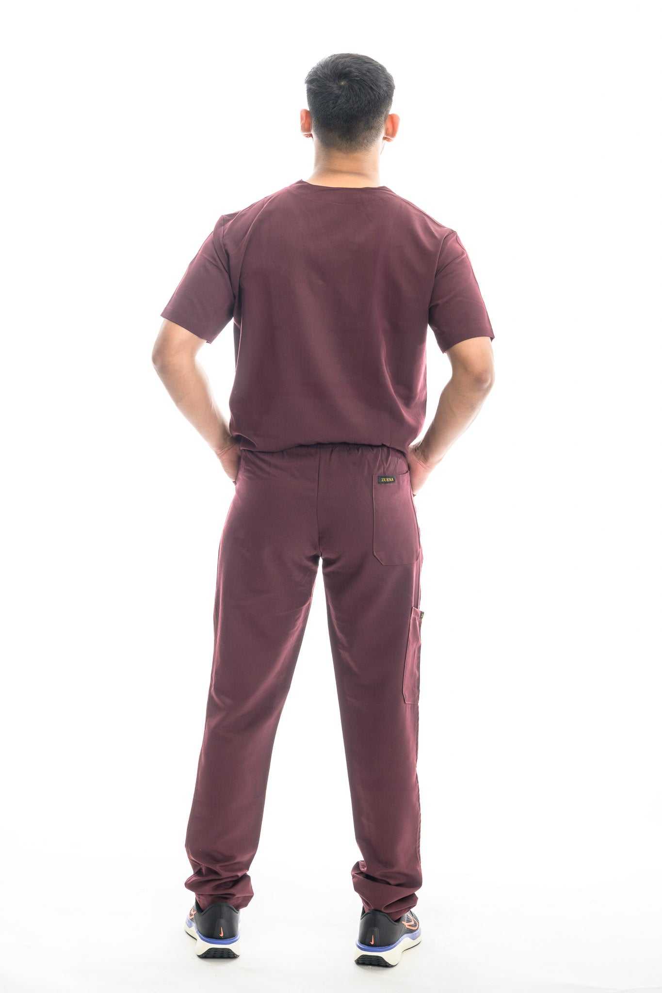 Burgundy Bloom scrubs set modeled from the back, featuring comfortable design and durable fabric for healthcare professionals.