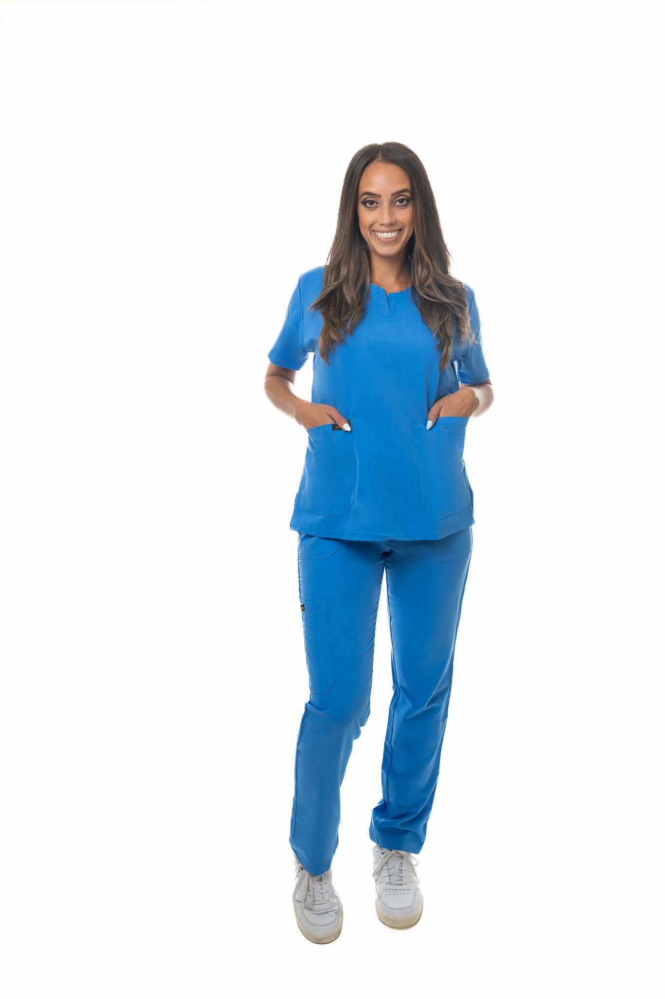 Female healthcare professional wearing blue Zuena Skyward Bound scrub bottom with elastic waistband and multiple pockets