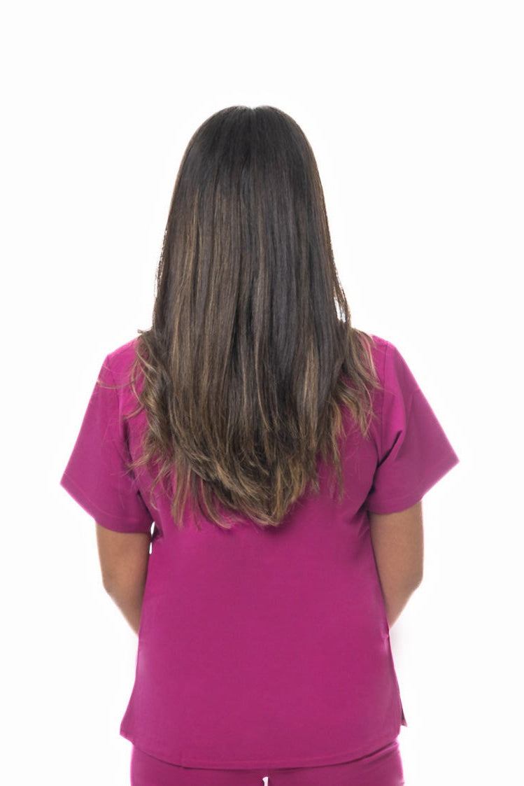Back view of Zuena Rose Petal Scrub Top in rose petal color with short sleeves and side vents
