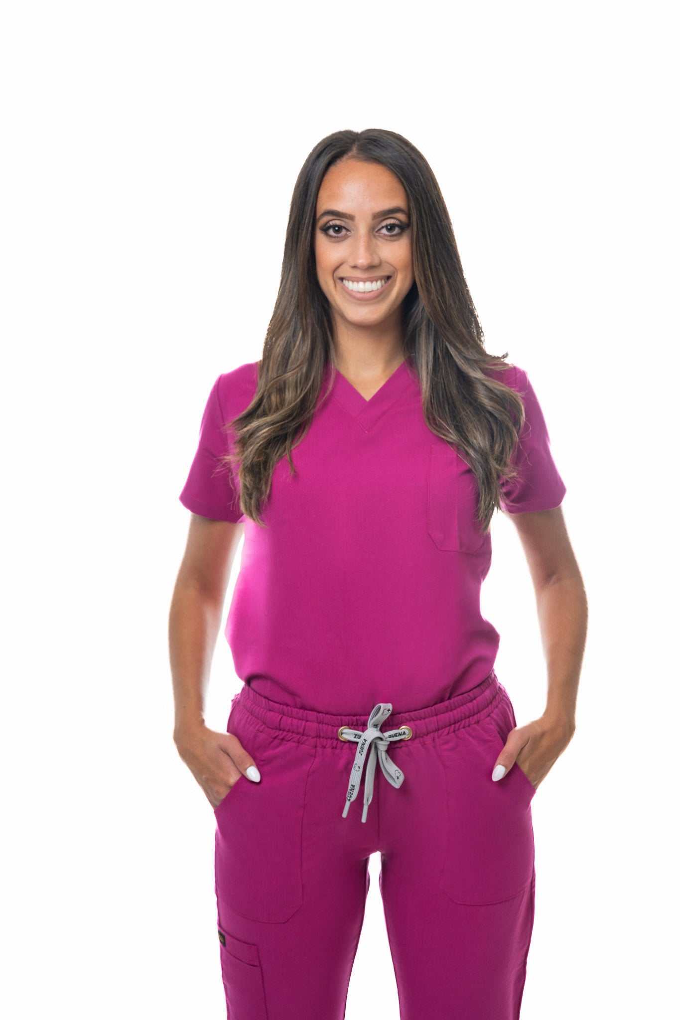 Woman wearing Zuena Rose Petal Scrub Pants with elastic waistband and multiple pockets in magenta color