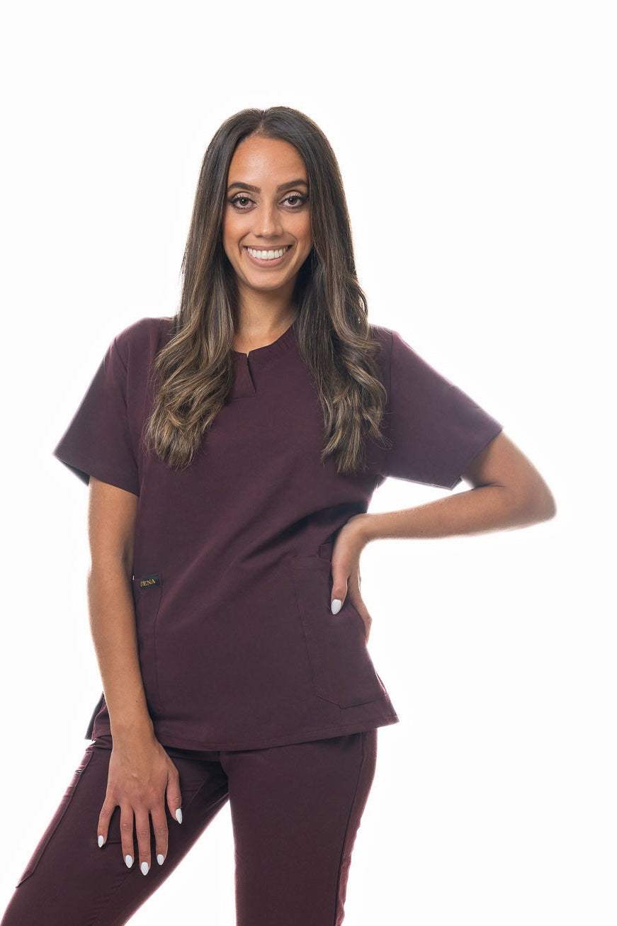 Zuena Burgundy Bloom scrub top with curved neck collar, three pockets, short sleeves, and side vents in burgundy color.